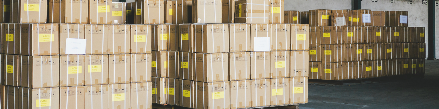 Stacks of cardboard boxes with labels in a warehouse setting