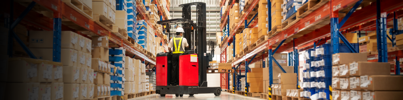 Forklift in a warehouse with shelves and boxes